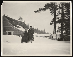 Man and woman standing in front of cabin