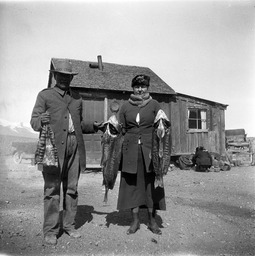 Paiute man and white woman with dried fish