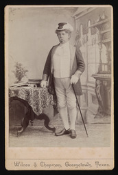 Unidentified man standing next to a table