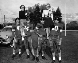 Football players with homecoming court members, University of Nevada, 1955