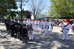 Marching band and young Basque dancers in two lines