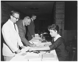 Harold Frey and Kooman Boycheff register with Mary Oxendine for the Western College Men's Physical Education Society conclave