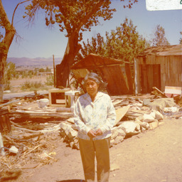 Henry Moses' daughter in front of his dismantled house