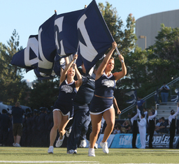 Cheerleaders with flag at University of Nevada football game, August 30, 2008