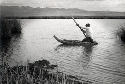 Jimmy George in tule and cattail boat