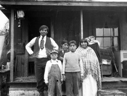 Paiute family in front of house