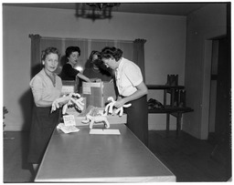 Women inventorying objects in boxes