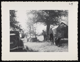 Two men next to car and shed, copy 1