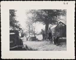 Two men next to car and shed, copy 2