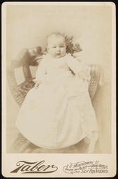 Andrew Jasper Harrell as a baby in a white dress