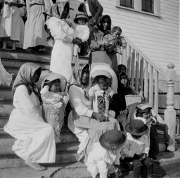 Group of women and children on steps of church