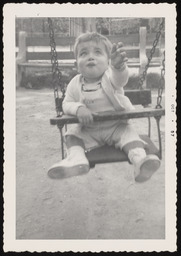 Kenneth Church as a baby sitting in swing