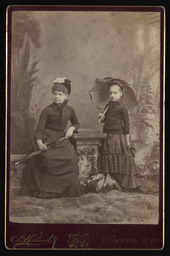 Unidentified woman and girl with an umbrella