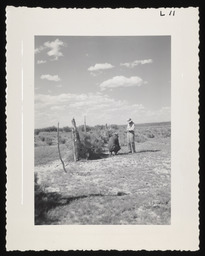 Two men next to wire fence, copy 2