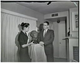 Dr. Charles J. Armstrong next to his bust sculpted by Jolande Jacobson, 1