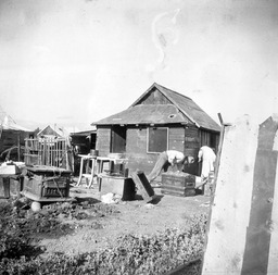 Man and woman working on outside of a house