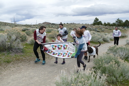 Participants running with banner