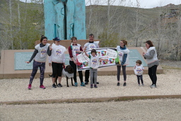 Participants with banner in front of monument