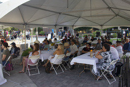 Commemoration guests sitting under tent