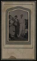 Four women and a man standing in a field