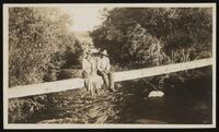 Man and woman sitting on a beam