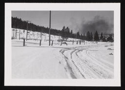 Tire tracks in snow with smoky sky, copy 2