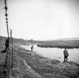 Men fishing in river