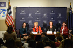 Hillary Clinton and women's healthcare round-table panel listening to audience member, close view
