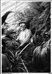 Agriculture Experiment Station Greenhouse with student, 1920