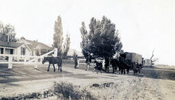 Men with horse-drawn wagon in front of Pyramid Lake Dude Ranch