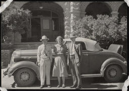 Three people standing in front of car at Lincoln Hall