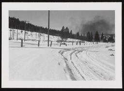 Tire tracks in snow with smoky sky, copy 4