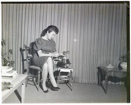 A woman modeling a fondue pot