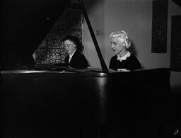 Alleta Gray and Helen Grimes playing the piano