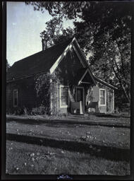 Front of Church residence with leaves on lawn