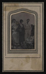 Four women and a man standing in a field
